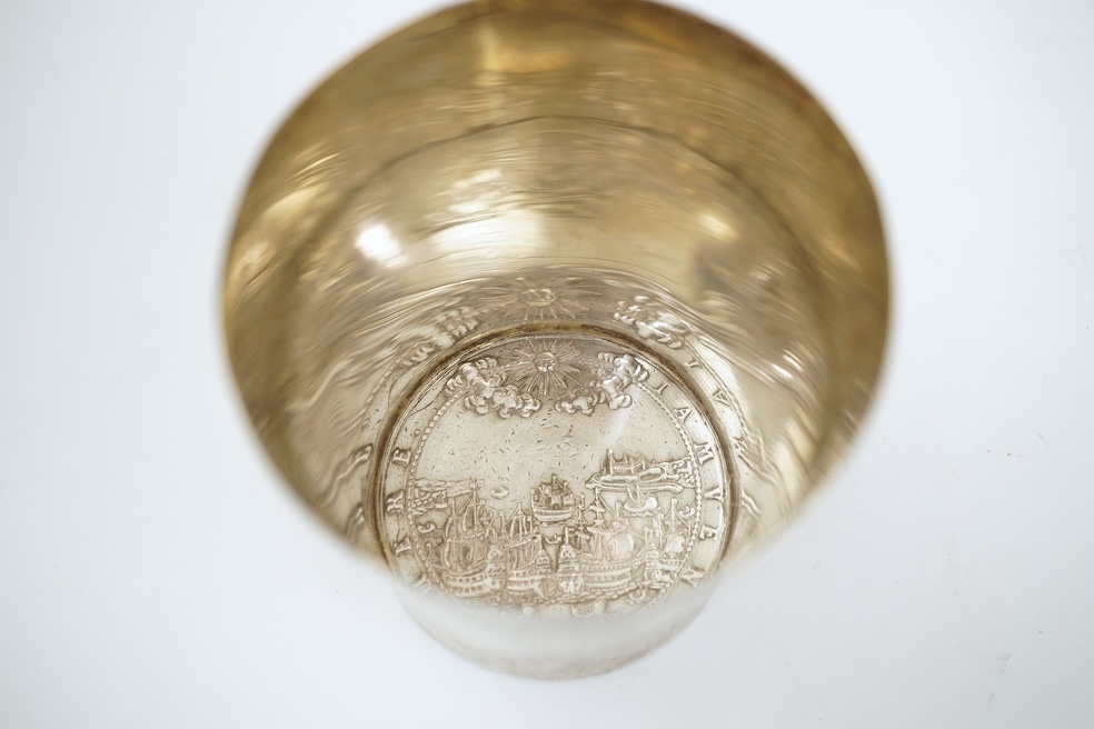 A white metal beaker the base inset with a silver medal commemorating the Peace of Oliva, 1660, Obv. Bird's-eye view of the city of Danzig with troops moving in foreground; above, an eagle crowned, an olive branch in its